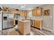 Bright kitchen features stainless steel appliances, an island, and wood cabinets at 4157 Taunton Ct, Plainfield, IN 46168