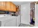Functional laundry room with modern washer and dryer, plus extra storage cabinets at 4157 Taunton Ct, Plainfield, IN 46168