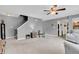 Cozy living room with staircase and view into the kitchen at 4157 Taunton Ct, Plainfield, IN 46168