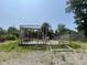 Framing of new construction with exposed beams and trusses on a lot with gravel and a partially collapsed building at 4566 Melbourne Rd, Indianapolis, IN 46228