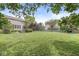Spacious backyard featuring lush greenery, mature trees, and a cozy fire pit area at 4642 Big Run Ct, Indianapolis, IN 46239
