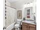 Bathroom with granite vanity, white fixtures, and shower with decorative curtain at 4642 Big Run Ct, Indianapolis, IN 46239