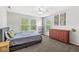 Comfortable bedroom with carpet, a ceiling fan, three windows, and a dresser providing ample storage at 4642 Big Run Ct, Indianapolis, IN 46239