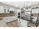 Modern kitchen featuring stainless steel appliances, granite countertops, and custom cabinetry with a kitchen island and barstools at 4642 Big Run Ct, Indianapolis, IN 46239