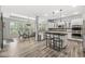 Open concept kitchen with stainless steel appliances, a large island, and abundant natural light flowing into a dining area at 4642 Big Run Ct, Indianapolis, IN 46239