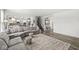 Spacious living room with gray couches and an open layout flowing into the kitchen and dining areas at 4642 Big Run Ct, Indianapolis, IN 46239