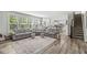 Bright and airy living room featuring large windows and comfortable seating, seamlessly connecting indoor and outdoor spaces at 4642 Big Run Ct, Indianapolis, IN 46239