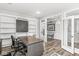 Bright home office with built-in bookshelves and glass paneled doors offers a functional and stylish workspace at 4642 Big Run Ct, Indianapolis, IN 46239