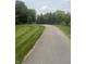 Paved path winds through a lush green lawn and mature trees, offering a scenic walking route at 4642 Big Run Ct, Indianapolis, IN 46239