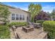 Backyard patio area with outdoor seating, a fire pit, and lush landscaping at 4642 Big Run Ct, Indianapolis, IN 46239
