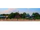 Community playground featuring climbing structures, slides, and swings set against a backdrop of mature trees at 4642 Big Run Ct, Indianapolis, IN 46239