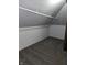 An attic storage area with neutral walls, comfortable carpeting, and a hanging bar at 509 Shelby St, Shelbyville, IN 46176