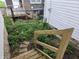 Backyard with potential for landscaping, featuring stairs, overgrown plants, and fencing at 509 Shelby St, Shelbyville, IN 46176