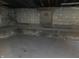 Unfinished basement with concrete walls and floor, offering ample storage space at 509 Shelby St, Shelbyville, IN 46176