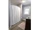 Bathroom with new LVP flooring, vanity and shower with white curtain at 509 Shelby St, Shelbyville, IN 46176