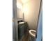 Small bathroom features a toilet, sink, and a vanity with a dark marbled countertop at 509 Shelby St, Shelbyville, IN 46176