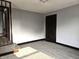 A bedroom featuring neutral walls, dark trim, plush carpet, and stairs to another level at 509 Shelby St, Shelbyville, IN 46176