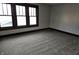 A well-lit bedroom featuring neutral walls, dark trim, and plush carpeting at 509 Shelby St, Shelbyville, IN 46176