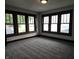 A bedroom featuring three windows and neutral colored carpeting at 509 Shelby St, Shelbyville, IN 46176