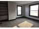 A bright bedroom featuring neutral walls, dark trim, plush carpet and windows at 509 Shelby St, Shelbyville, IN 46176