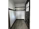 The bedroom closet has carpeted floors, shelves and rack for hanging clothes at 509 Shelby St, Shelbyville, IN 46176