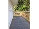 An exterior shot of a deck area featuring a wooden railing and gray carpeting at 509 Shelby St, Shelbyville, IN 46176