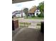 View of neighboring homes from front porch, showing steps and concrete walkway at 509 Shelby St, Shelbyville, IN 46176