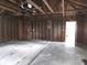 Spacious two car garage ready to be customized with garage door, rafters, and concrete floor at 509 Shelby St, Shelbyville, IN 46176