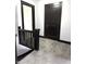 Hallway with dark wood trim, neutral carpet, and access to additional rooms at 509 Shelby St, Shelbyville, IN 46176
