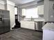 The kitchen has stainless steel refrigerator, marbled countertops, and modern appliances at 509 Shelby St, Shelbyville, IN 46176