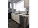 A bright kitchen with stainless steel appliances, white countertops, and updated cabinets at 509 Shelby St, Shelbyville, IN 46176