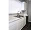 Bright kitchen features white cabinets, marbled countertops, stainless steel sink, and modern faucet at 509 Shelby St, Shelbyville, IN 46176