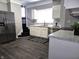Spacious kitchen featuring stainless steel appliances, white cabinets and luxury vinyl plank flooring at 509 Shelby St, Shelbyville, IN 46176