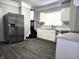 This kitchen features stainless steel refrigerator, marbled countertops, and dark wood vinyl floors at 509 Shelby St, Shelbyville, IN 46176