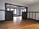 Open living space features hardwood floors, classic trim, and seamless transitions to other rooms via open doorways at 509 Shelby St, Shelbyville, IN 46176