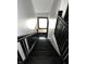 View of the stairway leading down, with a window providing natural light at 509 Shelby St, Shelbyville, IN 46176