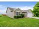 Beautiful home with a green lawn, stone accents, and a two-car garage in a well-maintained neighborhood at 5258 Brassie Dr, Indianapolis, IN 46235
