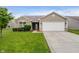Charming single-Gathering home with a two-car garage, well-manicured lawn and stone accents on the facade at 5258 Brassie Dr, Indianapolis, IN 46235
