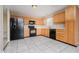 Functional kitchen with light wood cabinets, modern appliances, and tile floors for easy maintenance at 5258 Brassie Dr, Indianapolis, IN 46235