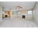 Open-concept living room flows into the kitchen, highlighted by a fireplace and large windows for natural light at 5258 Brassie Dr, Indianapolis, IN 46235