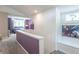 Hallway featuring purple accent wall and built-in bench seat, providing a unique space at 5315 Camden St, Indianapolis, IN 46227