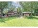 Spacious backyard featuring green lawn, patio area, mature trees, and lush landscaping at 5315 Camden St, Indianapolis, IN 46227
