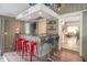 Stylish bar area with seating, shelving, and views into the living room at 5315 Camden St, Indianapolis, IN 46227