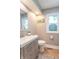 Bright bathroom featuring wood floors, light gray walls, and a stylish vanity at 5315 Camden St, Indianapolis, IN 46227