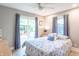 Comfortable bedroom with a ceiling fan, sliding glass door to a deck, and blue patterned bedding at 5315 Camden St, Indianapolis, IN 46227