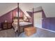 Attic bedroom featuring a canopy bed, bedside tables, and carpet flooring at 5315 Camden St, Indianapolis, IN 46227