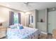 Bright bedroom with mirrored closet, ceiling fan, and natural light from the window at 5315 Camden St, Indianapolis, IN 46227
