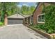 Charming brick home with a black garage door and a beautifully landscaped walkway at 5315 Camden St, Indianapolis, IN 46227