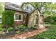 Front exterior of a brick home with stone accents, lush landscaping, and brick walkway at 5315 Camden St, Indianapolis, IN 46227