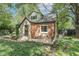 Charming brick home with a stone accent entrance and an inviting front porch area with seating at 5315 Camden St, Indianapolis, IN 46227